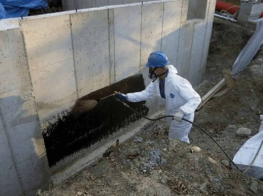 Professional waterproofing the exterior walls of the basement in Tempe, AZ