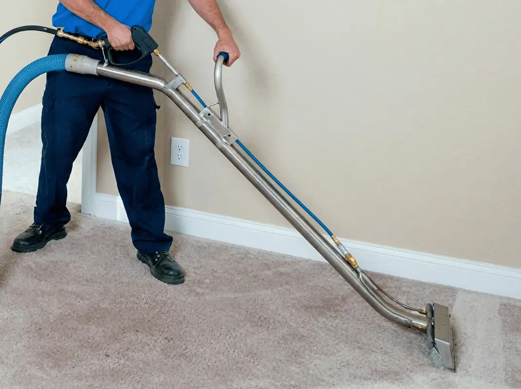 Professional operating a liquid removal machine on a carpeted floor in Tempe, AZ